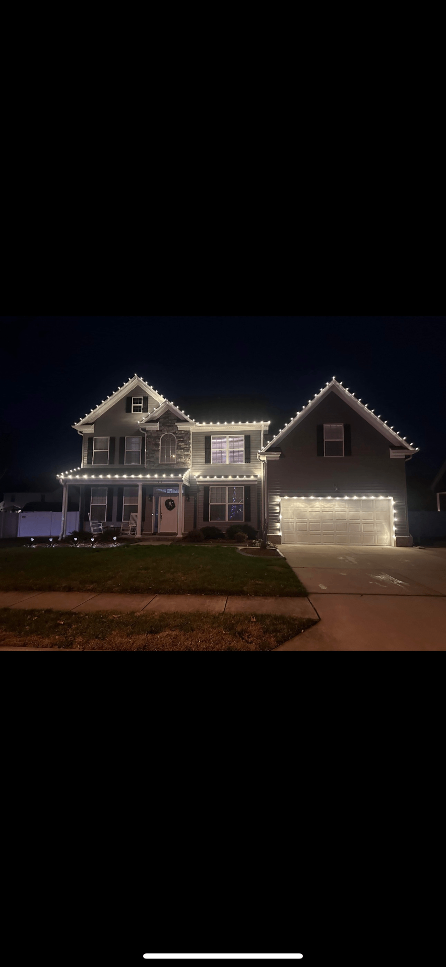 Custom cut Christmas lights on a two-story home