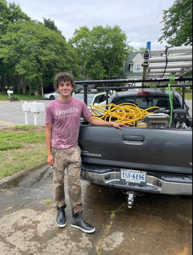 Kyle, owner of Washway Exterior Services, standing by his work truck in Virginia